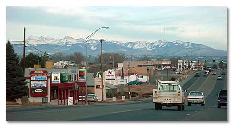 Main street in downtown Cortez, Colorado with San Juan Mountains in the distance