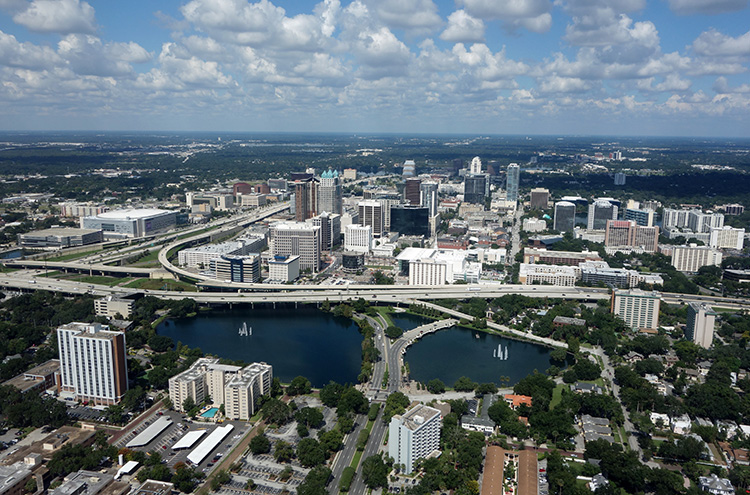 Aerial view of downtown Orlando with highways, high-rises, and lakes in Orange County