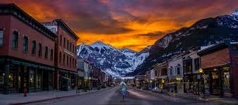 Main Street Telluride at sunset with snow-capped mountains