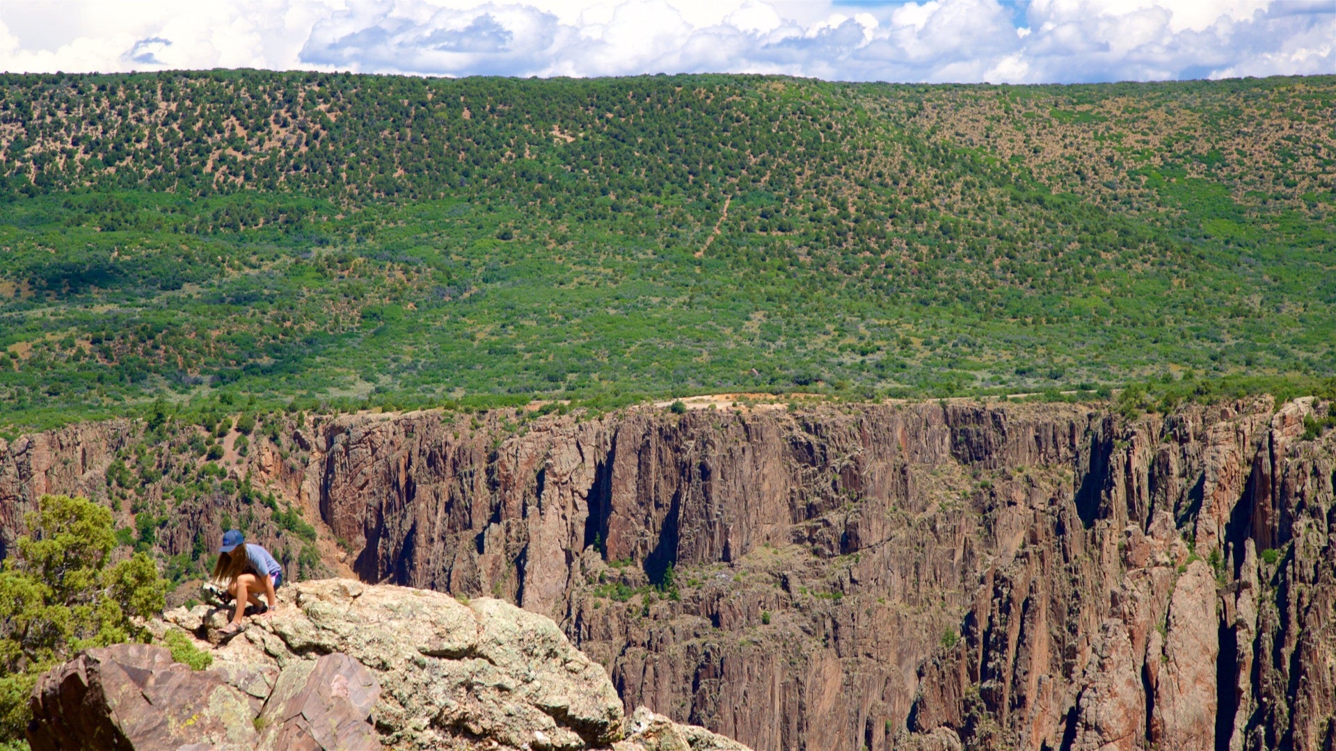 Hiker on a rim overlook above the Black Canyon of the Gunnison near Montrose, Colorado