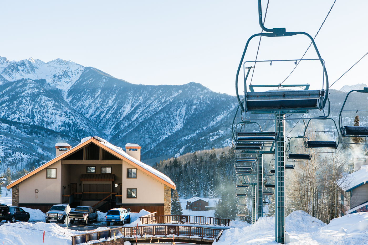 Purgatory Resort ski lift with snow-capped San Juan Mountains