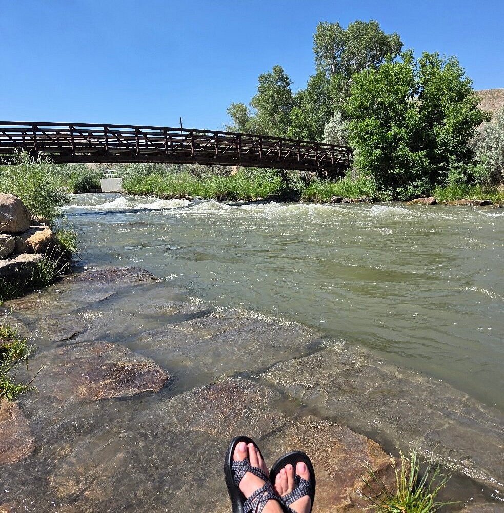 Pedestrian bridge over the Uncompahgre River in Montrose, Colorado on a summer afternoon